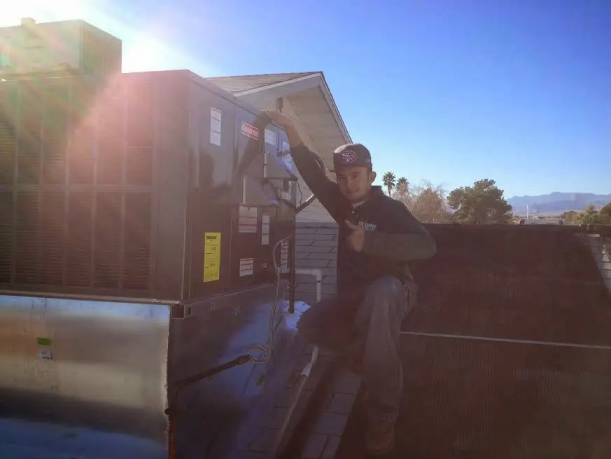 HVAC technician performing Boiler Repair on a rooftop unit in Lompoc